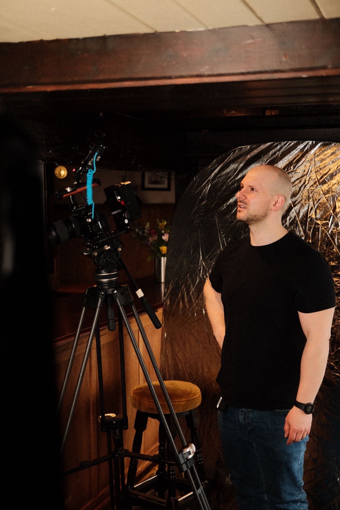 Adam Drake on set during a brand film shoot, working with the camera crew