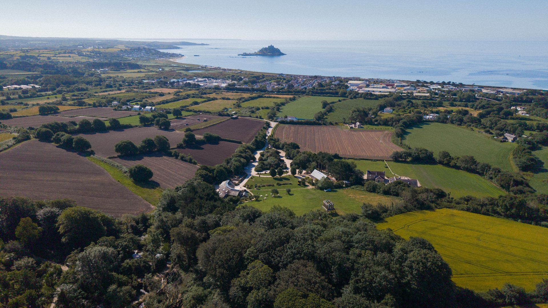 Aerial view over Tremenheere Sculpture Gardens with St Michael's Mount in the distance, Cornwall